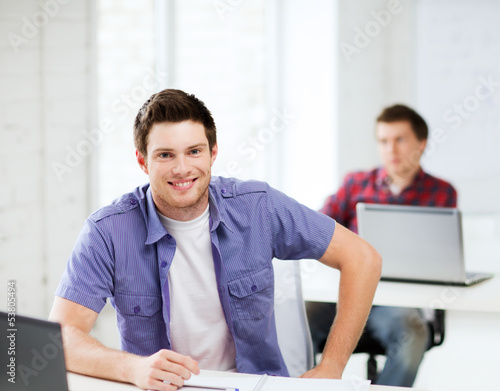 Photo: smiling student with laptop at school smiling student with laptop at school