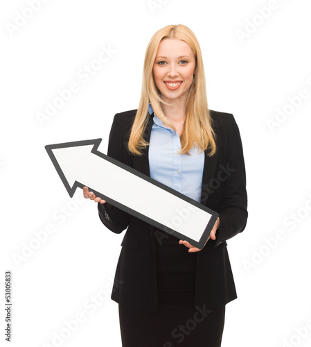 Photo: smiling businesswoman with direction arrow sign smiling businesswoman with direction arrow sign