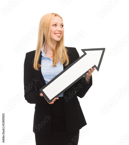 Photo: smiling businesswoman with direction arrow sign smiling businesswoman with direction arrow sign