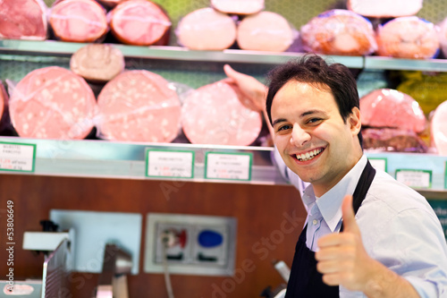 Photo: Smiling shopkeeper Smiling shopkeeper