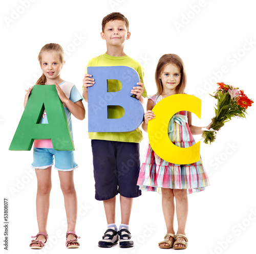 Photo: Children holding abc. Children holding abc.