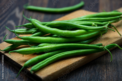 Photo: Green Beans on wooden old plank Green Beans on wooden old plank