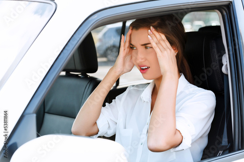 Photo: Troubles on the road, girl touches her forehead by hands Troubles on the road, girl touches her forehead by hands