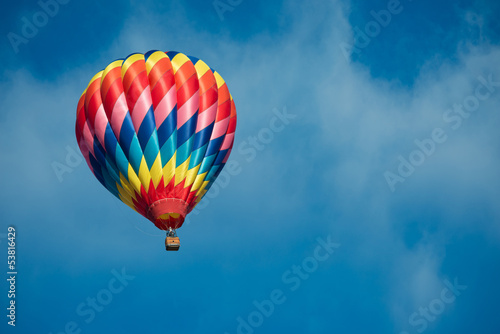 Photo: Brightly colored hot air balloon with a sky blue background Brightly colored hot air balloon with a sky blue background