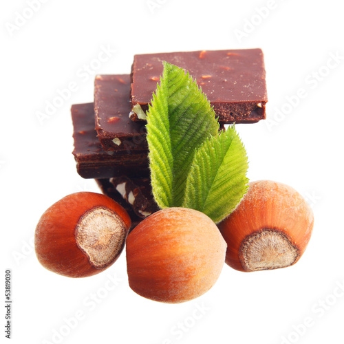 Photo: Chocolate and hazelnuts isolated on white background. Chocolate and hazelnuts isolated on white background.