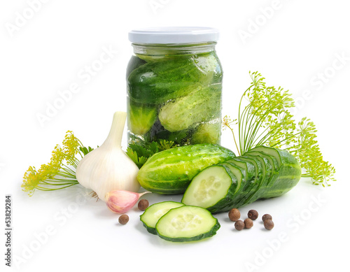 Photo: Preparing preserves of pickled cucumbers in jar with spices Preparing preserves of pickled cucumbers in jar with spices