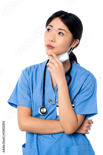 Photo: Female surgeon thinking something Female surgeon thinking something