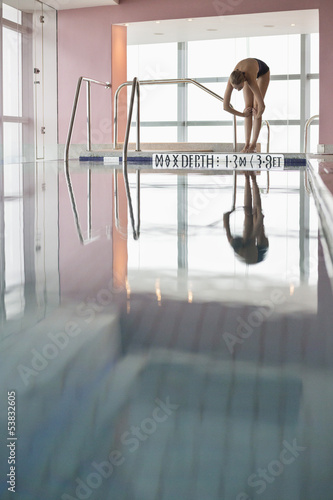 Photo: Woman diving into a swimming pool Woman diving into a swimming pool