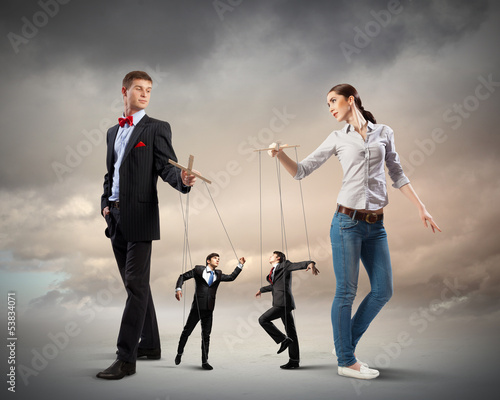 Photo: Businesspeople with marionettes Businesspeople with marionettes