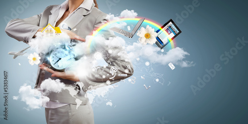 Photo: Business woman holding alarmclock Business woman holding alarmclock