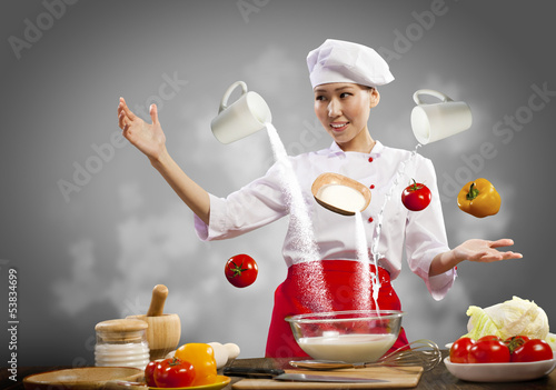 Photo: Asian female cooking with magic Asian female cooking with magic