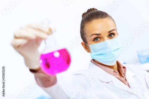 Photo: Young female scientist working in laboratory Young female scientist working in laboratory