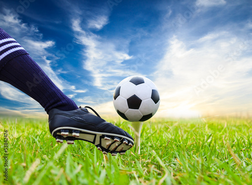 Photo: foot kicking soccer ball on golf tee foot kicking soccer ball on golf tee