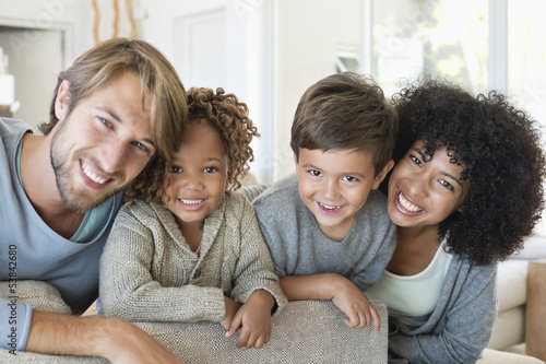 Photo: Portrait of a couple smiling with their children Portrait of a couple smiling with their children