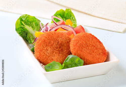 Photo: Fried cheese or fish cakes with fresh vegetables Fried cheese or fish cakes with fresh vegetables