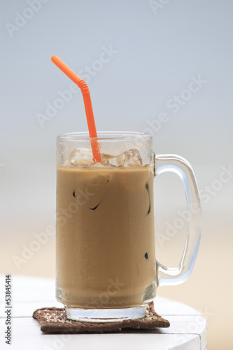 Photo: Iced coffee with straw in glass Iced coffee with straw in glass