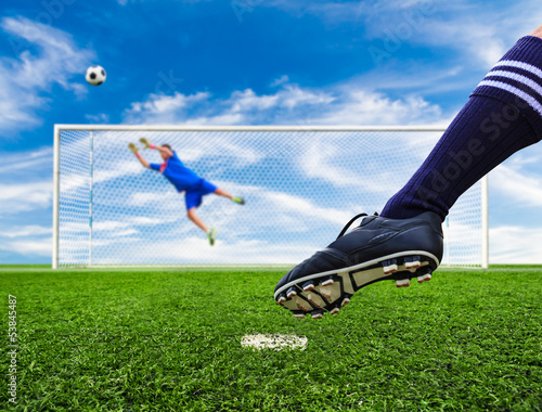 Photo: foot shooting soccer ball out of goal foot shooting soccer ball out of goal