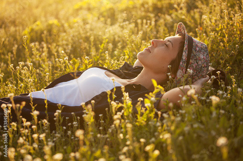 Photo: The girl in a hat dremet among wildflowers The girl in a hat dremet among wildflowers