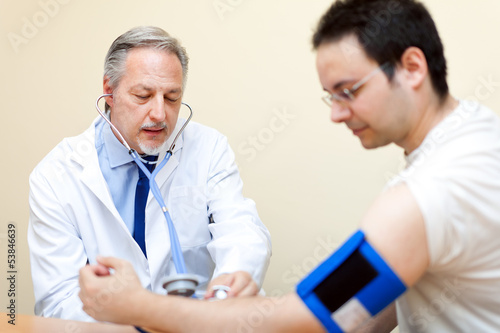 Photo: Doctor and patient with blood pressure meter Doctor and patient with blood pressure meter