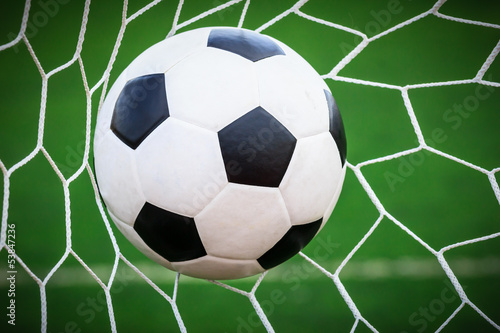Photo: soccer ball in goal net soccer ball in goal net