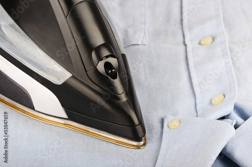 Photo: Steam iron on a gray shirt Steam iron on a gray shirt