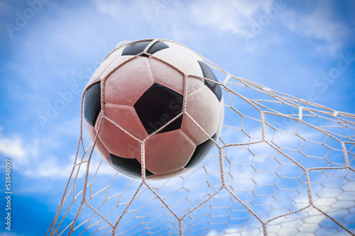 Photo: football in goal net football in goal net