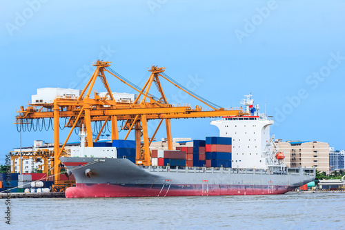 Photo: crane working with container cargo in shipyard crane working with container cargo in shipyard
