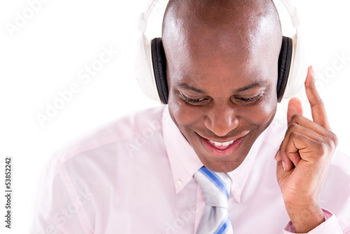 Photo: Business man listening to music Business man listening to music