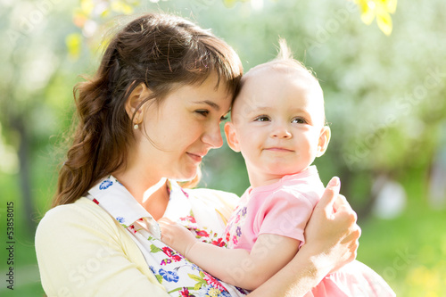 Photo: loving mother with baby girl outdoors loving mother with baby girl outdoors