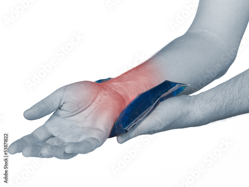 Photo: Wrist pain. Male holding ice pack on wrist. Wrist pain. Male holding ice pack on wrist.
