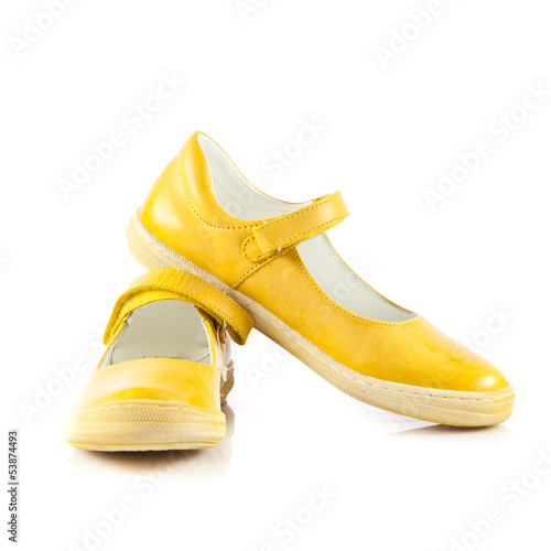 Photo: Children's shoes isolated over the white background. yellow sh Children's shoes isolated over the white background. yellow sh