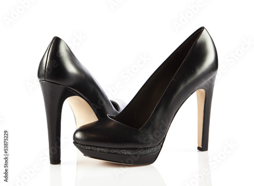 Photo: Elegant high heel shoes on white background. Black footwear. Elegant high heel shoes on white background. Black footwear.