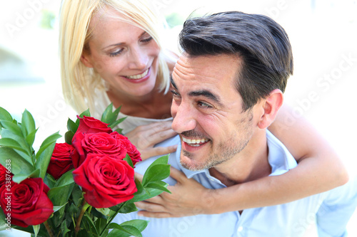 Photo: Man giving red roses to woman Man giving red roses to woman
