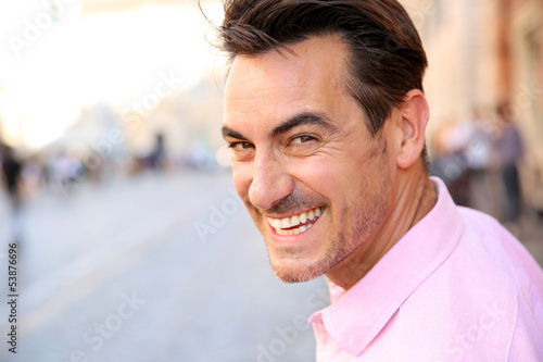 Photo: Closeup of handsome guy wearing pink shirt Closeup of handsome guy wearing pink shirt