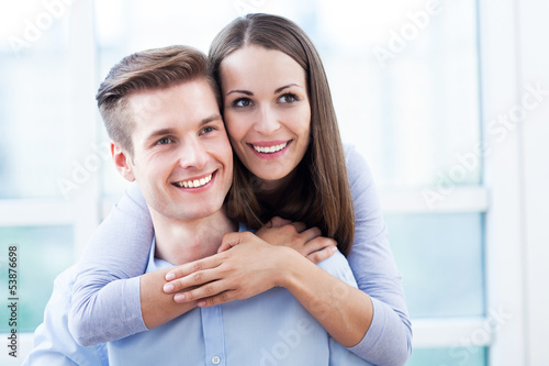 Photo: Smiling young couple hugging Smiling young couple hugging