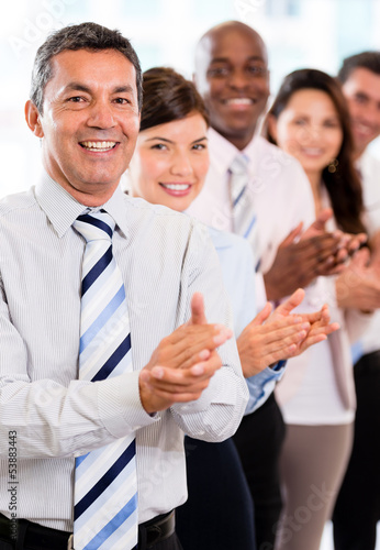 Photo: Business group celebrating their success Business group celebrating their success