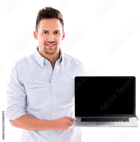 Photo: Man holding a laptop Man holding a laptop