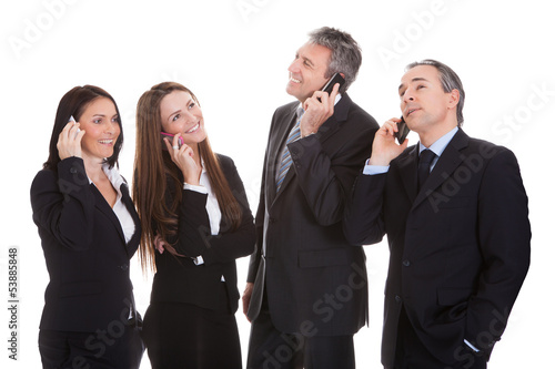 Photo: Business People Talking On Cell Phone Business People Talking On Cell Phone