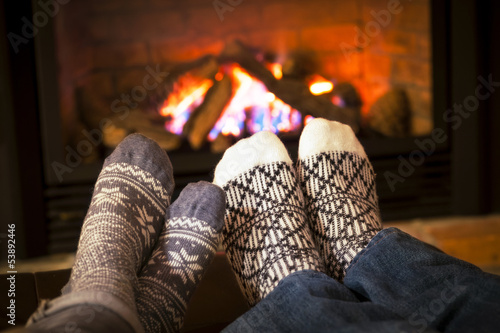 Photo: Feet warming by fireplace Feet warming by fireplace