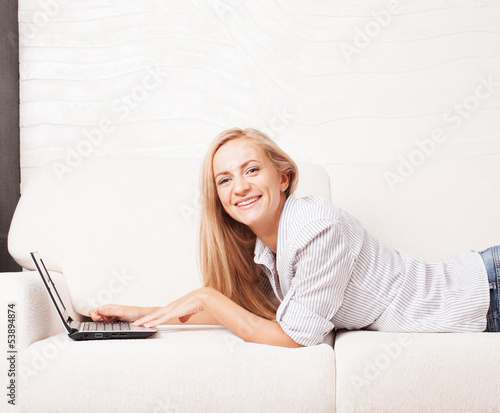 Photo: Woman on the sofa with laptop Woman on the sofa with laptop