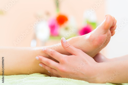 Photo: Woman in nail salon receiving foot massage Woman in nail salon receiving foot massage