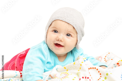 Photo: Baby girl with hat lying down and smiling Baby girl with hat lying down and smiling