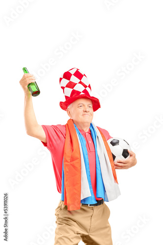 Photo: Mature male sport fan, with flag of Holland, holding a soccer ba Mature male sport fan, with flag of Holland, holding a soccer ba