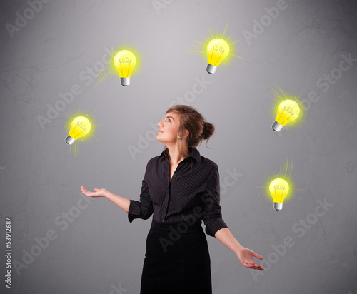 Photo: young lady standing and juggling with light bulbs young lady standing and juggling with light bulbs