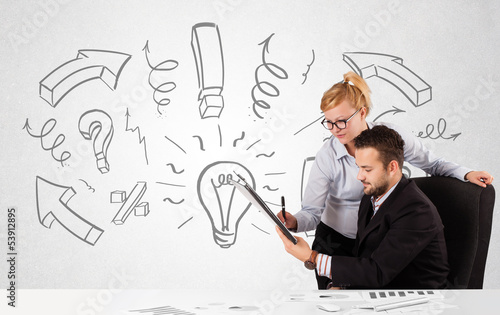 Photo: Businessman and businesswoman brainstorming with drawn arrows an Businessman and businesswoman brainstorming with drawn arrows an