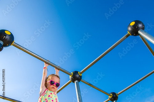 Photo: Girl and jungle gym Girl and jungle gym