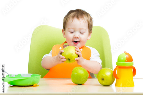 Photo: cute baby boy eating apple cute baby boy eating apple