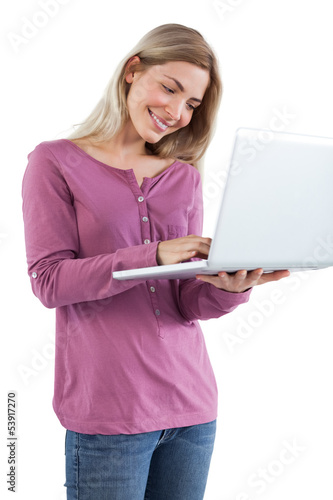 Photo: Blonde woman using a laptop Blonde woman using a laptop
