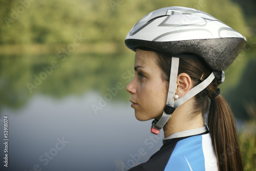 Photo: young woman training on mountain bike and cycling in park young woman training on mountain bike and cycling in park