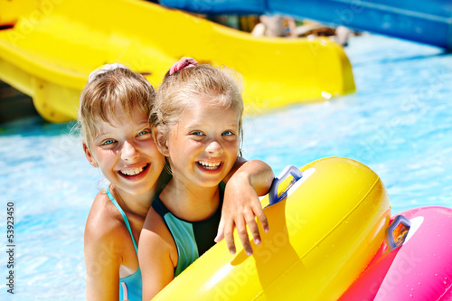 Photo: Child on water slide at aquapark. Child on water slide at aquapark.